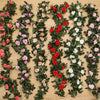 A lush green silk rose hanging vine garland featuring pink, red, and white roses for weddings and home decor.