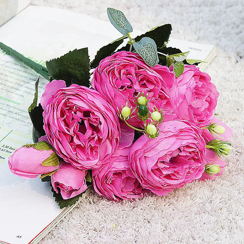 A vibrant pink silk rose and peony artificial bouquet featuring lush pink flowers on green foliage.