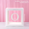 A white transparent box with a large white letter O inside, used for birthday and baby shower decorations.