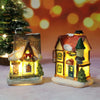 A festive Christmas house night light featuring a detailed building with warm LED glow and sparkling snow.