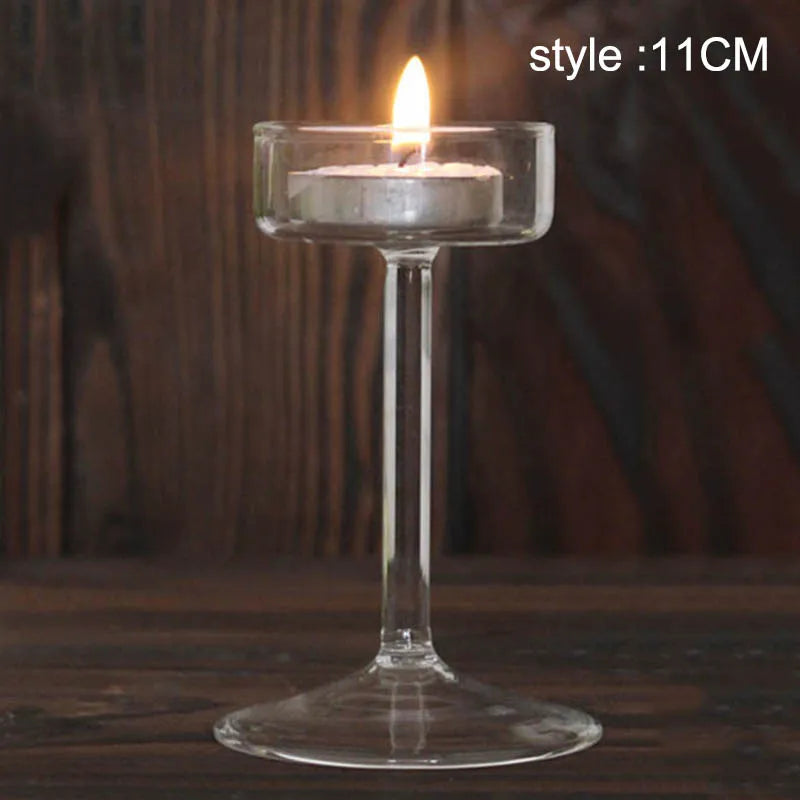 Elegant glass candle holder with a lit candle on a clear glass base