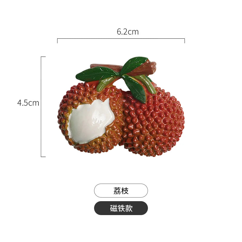A set of realistic fruit and vegetable fridge magnets featuring a textured, reddish-orange fruit with a white interior and gr