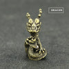 Brass statue of a dragon head with a smaller dragon coiled around its neck, used as an incense holder.