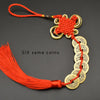 A set of six copper coins used as an I Ching Feng Shui charm with a handwoven knot and red cord.
