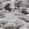 Silver heart-shaped sponge confetti scattered on a white surface.