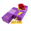 A purple box containing a 24K gold foil artificial rose with a red rose and gold leaves.