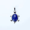 A silver pendant necklace featuring a deep blue natural stone shaped like an animal.