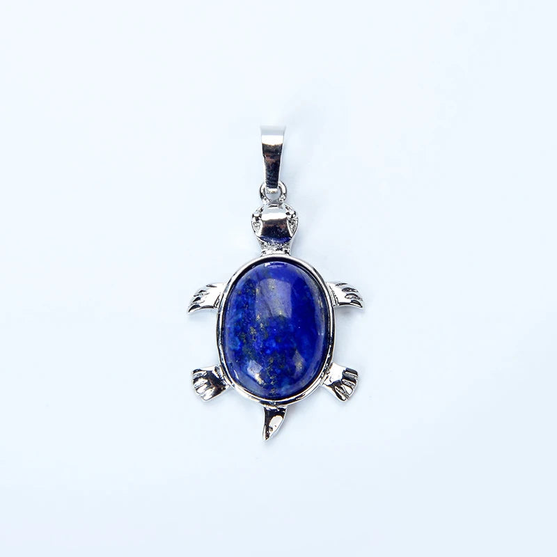 A silver pendant necklace featuring a deep blue natural stone shaped like an animal.