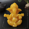 Handcrafted yellow Buddha statue for home and garden, shown from above.