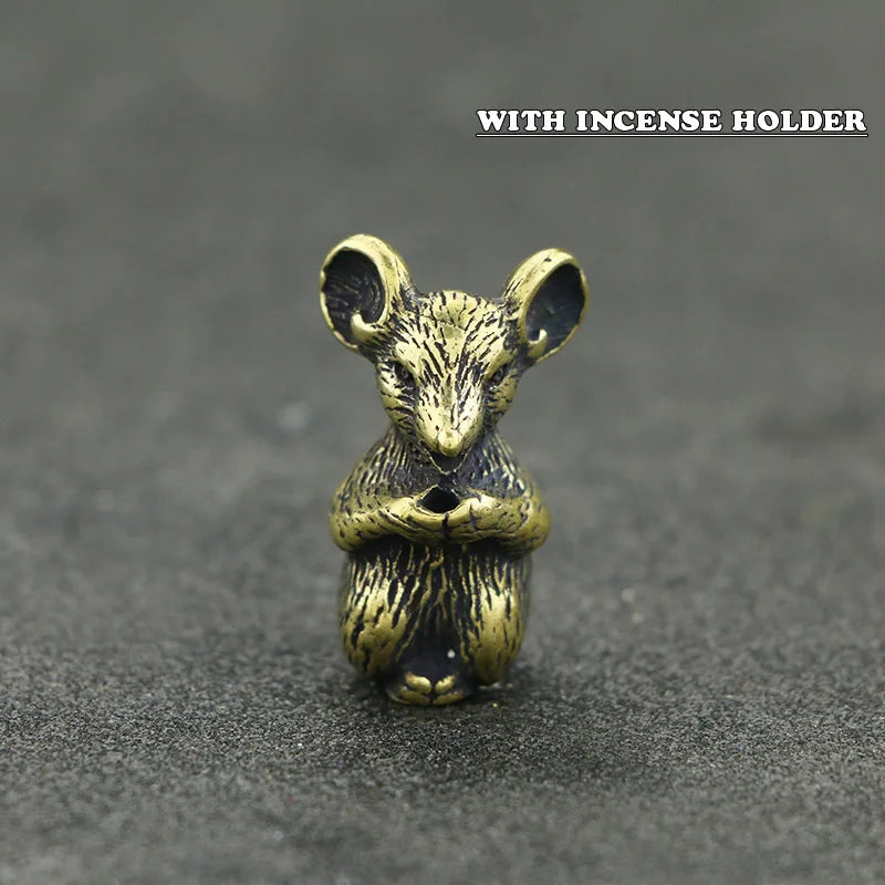 A small brass statue of a mouse with large ears, designed as an incense holder.