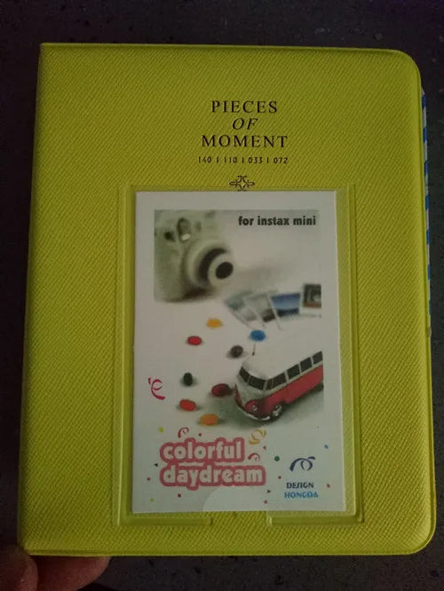 Yellow compact photo album titled Pieces of Moment for Instax mini film