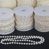 Rolls of ivory pearl beads and a finished pearl bead garland for wedding and event decoration