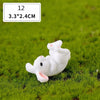 A small white rabbit figurine resting on green grass.
