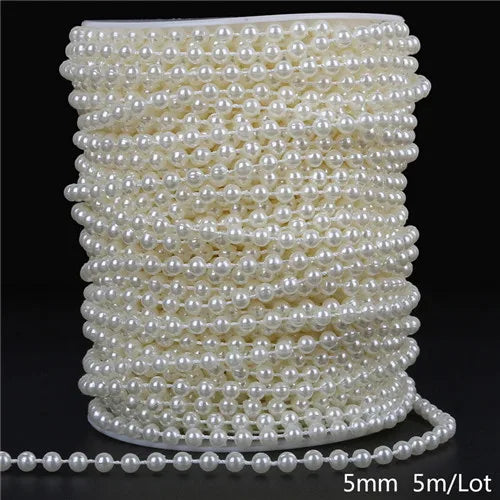 A spool of ivory pearl beads used for garland decoration, showing the beads laid out and a loose strand.