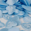 A pile of light blue heart-shaped sponge confetti for weddings and celebrations.
