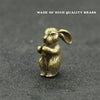 A small brass statue of a rabbit sitting with its paws together, used as an incense holder.
