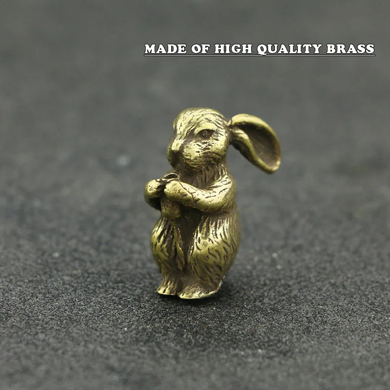 A small brass statue of a rabbit sitting with its paws together, used as an incense holder.
