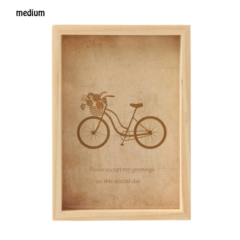 A light wooden photo frame with a vintage illustration of a bicycle and text inside.