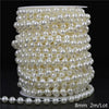 A spool of ivory pearl beads used for garlands and decoration, showing a coiled length of small spherical pearls.
