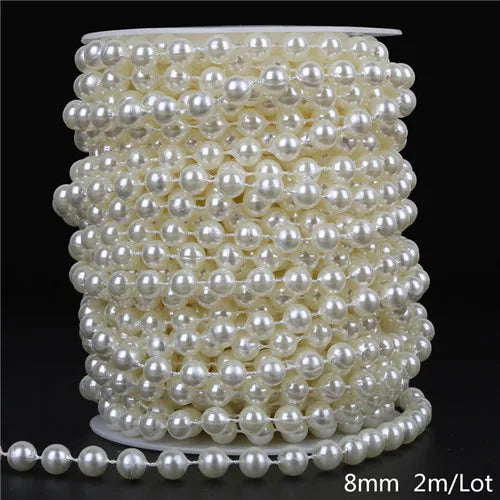 A spool of ivory pearl beads used for garlands and decoration, showing a coiled length of small spherical pearls.