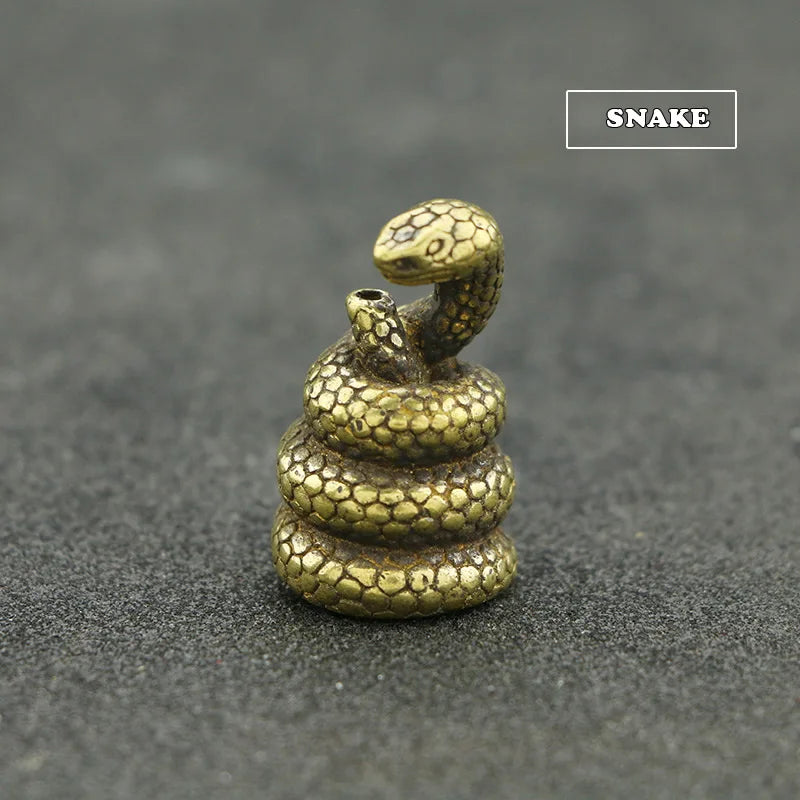 A brass statue of a snake, representing the Chinese Zodiac, with an incense holder.