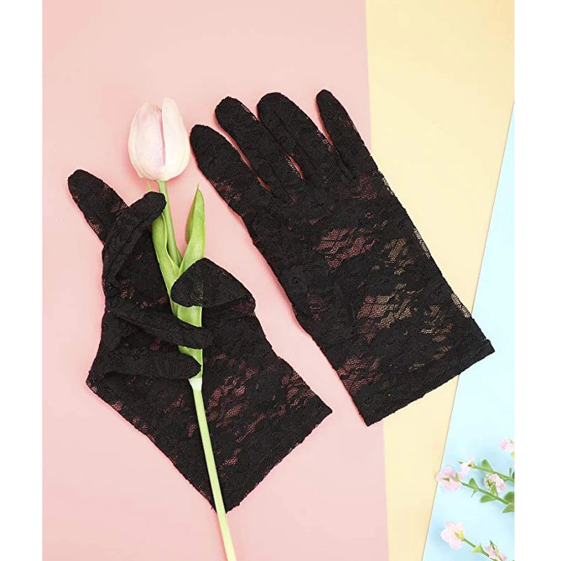 Pair of black sheer lace gloves with a pink tulip flower on a light pink background.