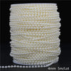 A spool of ivory pearl beads used for garlands and decoration.