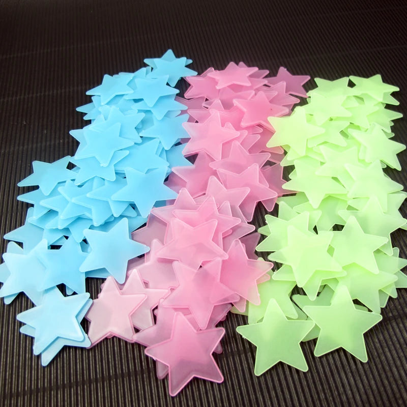 A collection of glow-in-the-dark star wall stickers in various shades of blue, pink, and green.