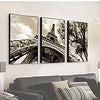 Three framed black and white photographs of a bridge and trees displayed on a white wall.