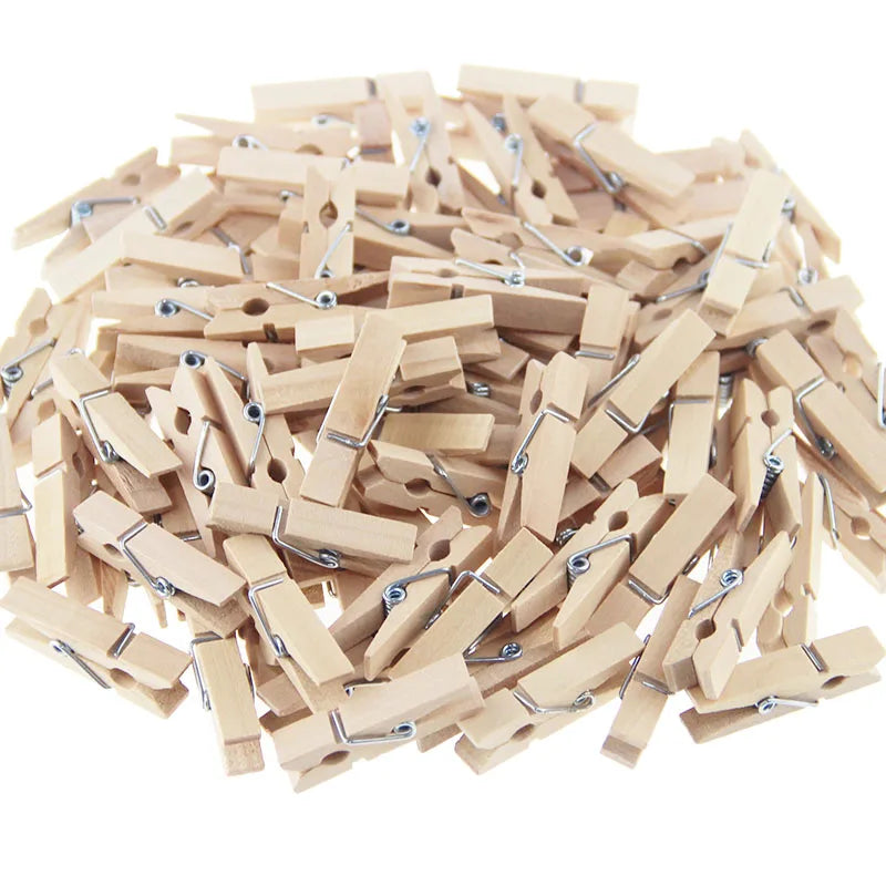 A pile of natural wooden clips used for crafts, photos, and decor.