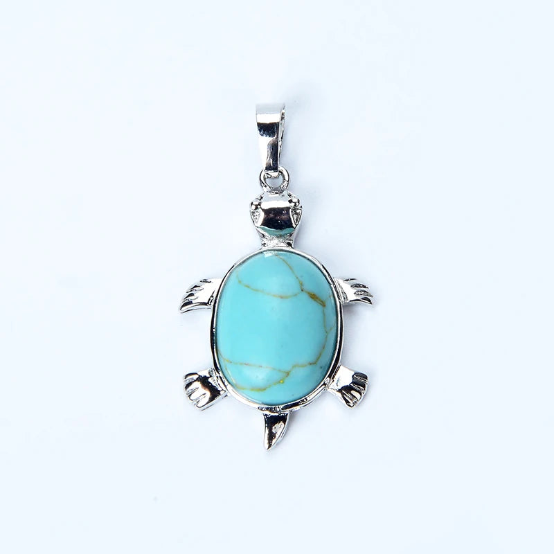 A turquoise stone pendant necklace shaped like an animal, featuring a silver bail and detailed carving.
