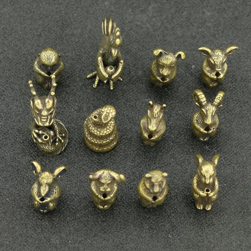 A collection of brass Chinese Zodiac animal statues, including a monkey, rabbit, and other zodiac animals.
