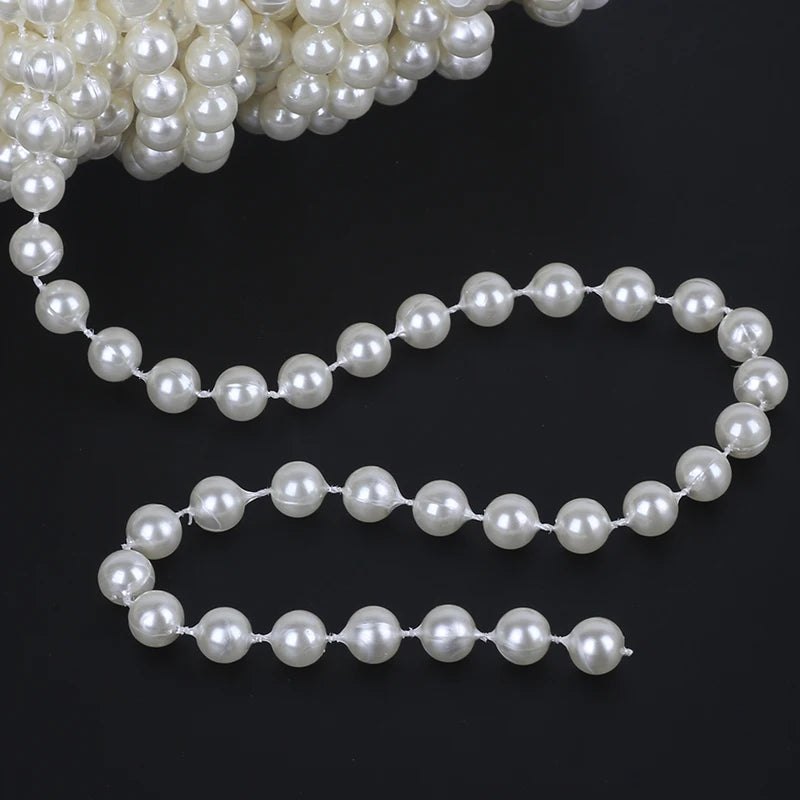 A string of white ivory pearl beads arranged in a garland shape.