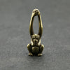 Vintage brass monkey key chain charm with a grasping hand design