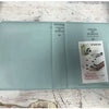 A light blue compact photo album with a clear cover and a section for instant film photos.
