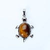 Silver pendant necklace featuring a polished, amber-colored natural stone shaped like an animal.