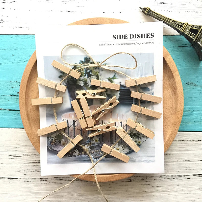 A sheet of paper featuring natural wooden clothespins arranged in a circular pattern for craft or decor