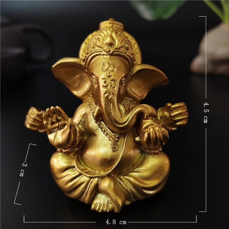 Gold handcrafted Buddha statue of an elephant sitting in a meditative pose