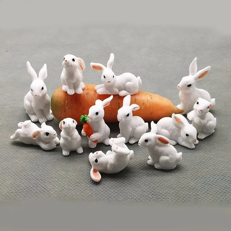 A collection of white miniature rabbit figurines sitting on an orange pumpkin.