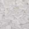 White heart-shaped sponge confetti scattered on a white surface