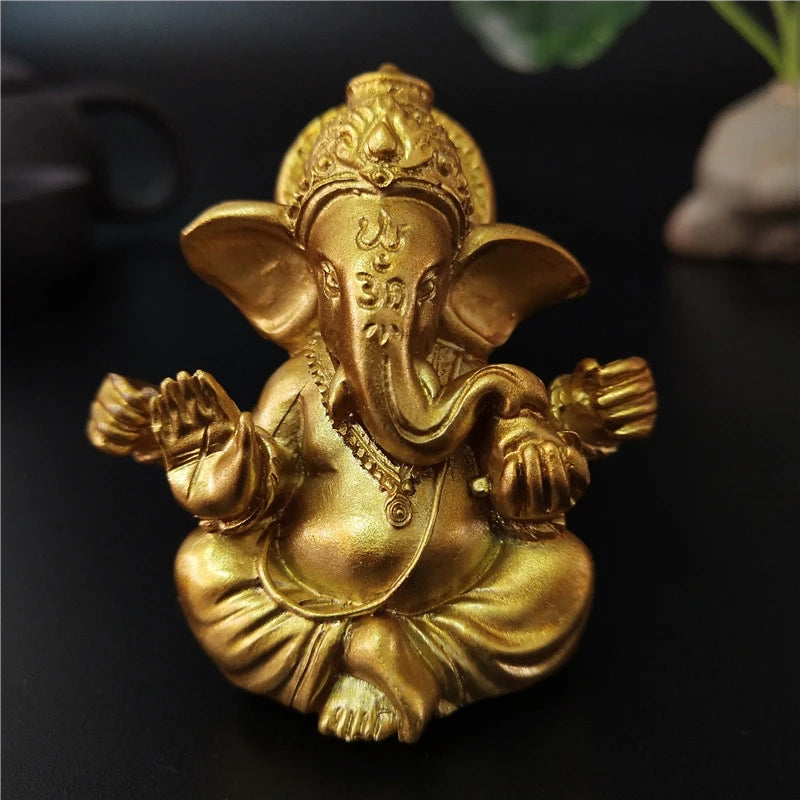 Golden handcrafted statue of the elephant Buddha sitting in a meditative pose