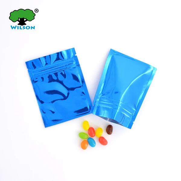 Two bright blue foil zip bags containing colorful candies are displayed on a white background.