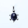 Silver pendant necklace featuring a polished dark blue stone shaped like an animal.
