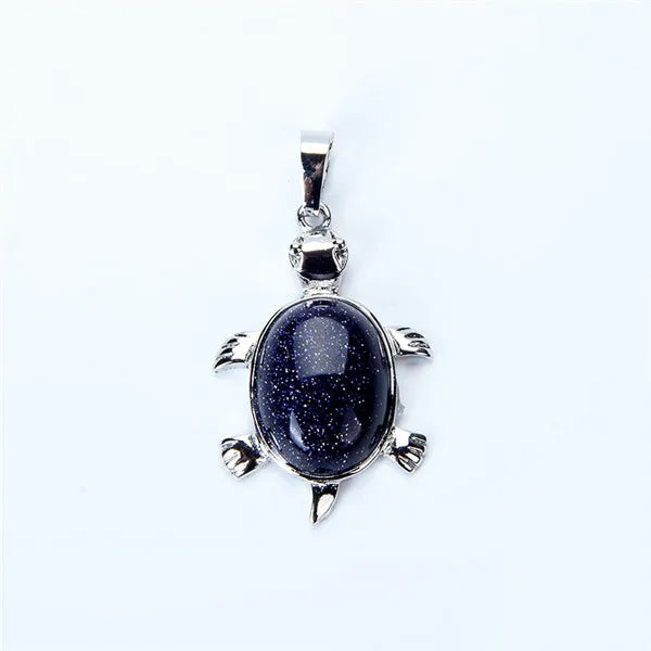 Silver pendant necklace featuring a polished dark blue stone shaped like an animal.