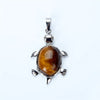 Silver pendant necklace featuring a polished, amber-colored natural stone shaped like an animal.
