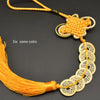A necklace featuring six copper coins tied together with a handwoven knot and a yellow cord.