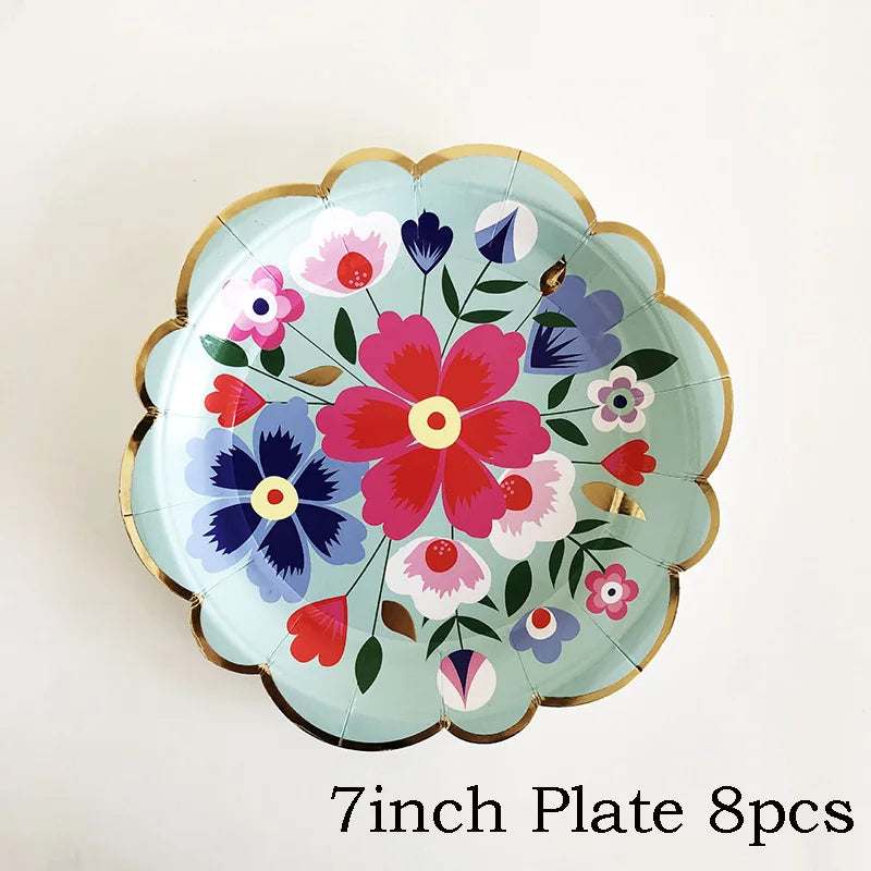 A light blue floral plate with pink, purple, and red flowers and a gold rim.