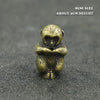 Mini brass statue of a Chinese zodiac animal with an incense holder on a dark surface.