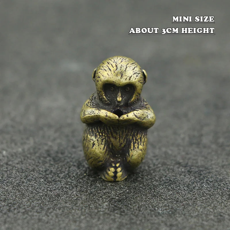 Mini brass statue of a Chinese zodiac animal with an incense holder on a dark surface.