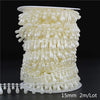 Ivory pearl bead garland featuring small, teardrop-shaped pearls arranged in multiple strands for decoration.